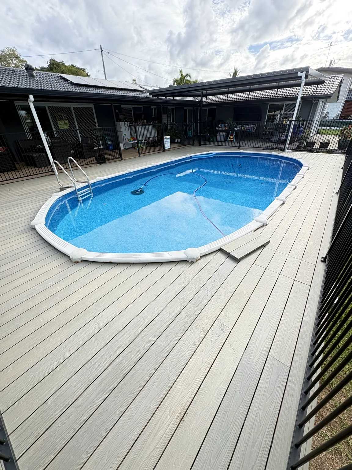 Composite deck surrounding a swimming pool