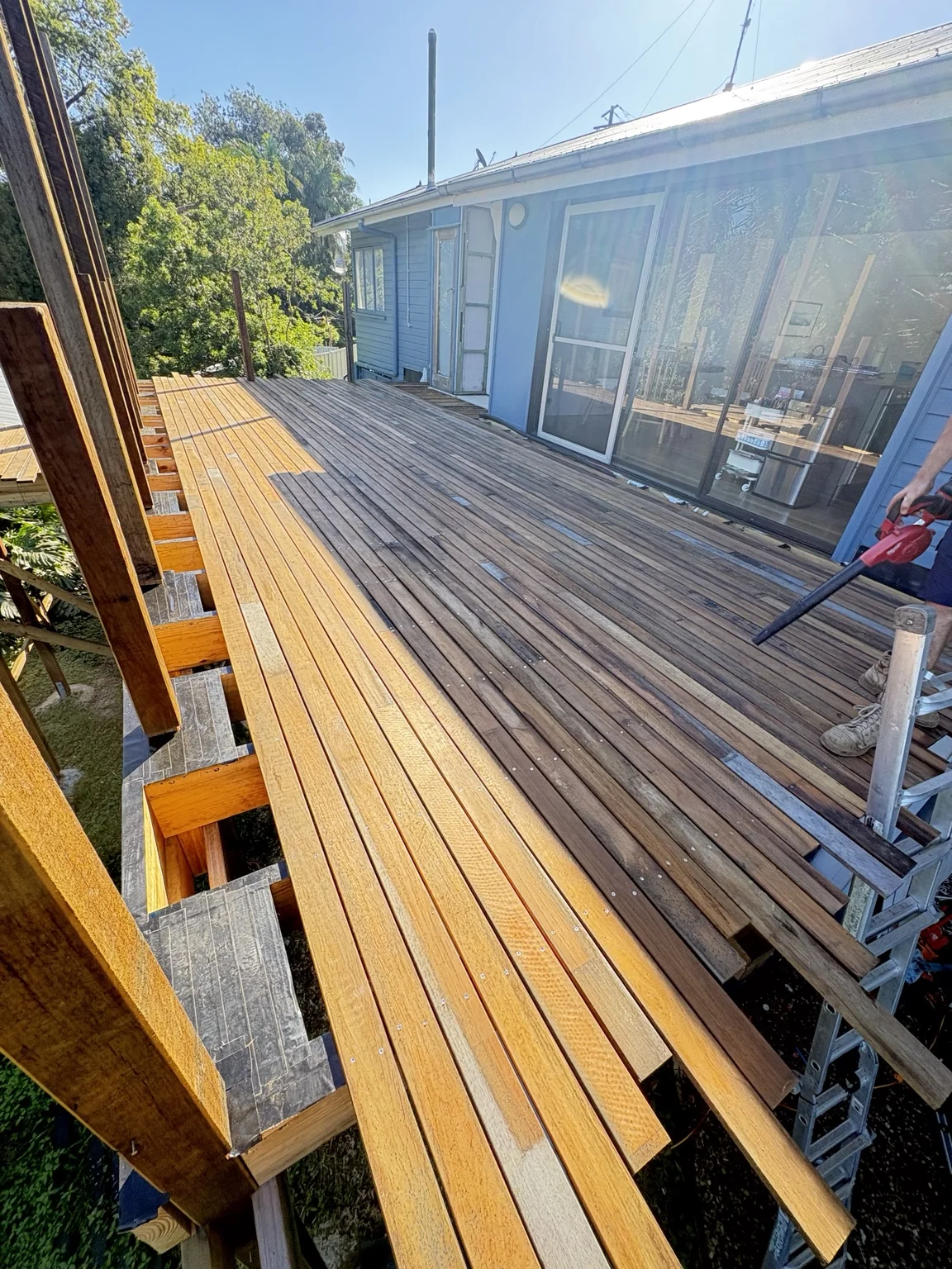 Timber deck renovation with new boards being installed