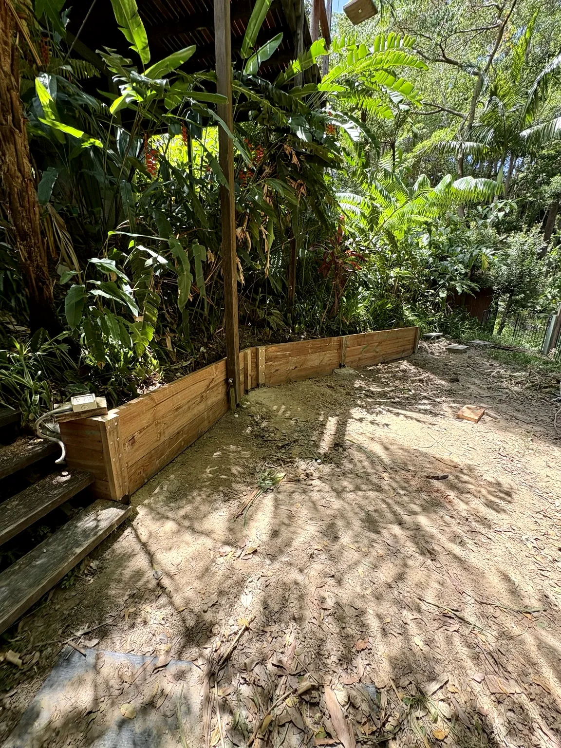 Timber retaining wall in a landscaped garden